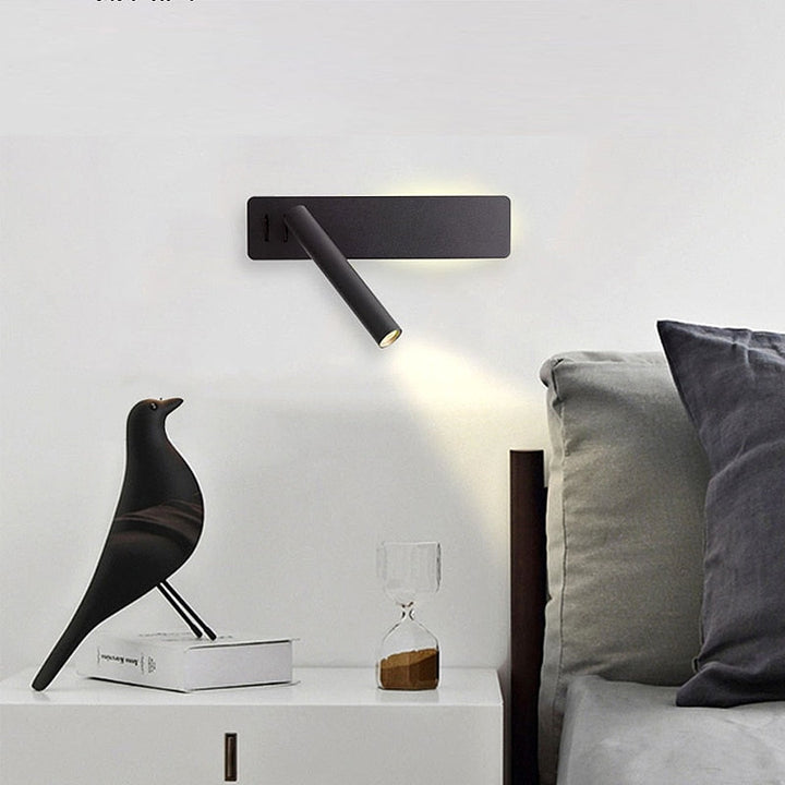 Black reading wall light above a bed