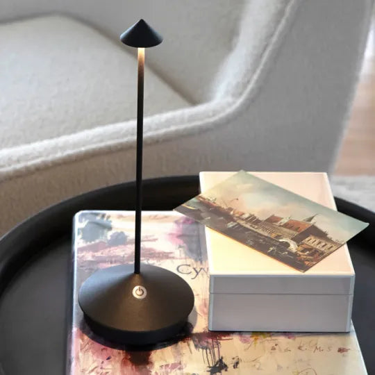 Cordless lamp beside a book